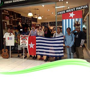 West Papua Association. People holding a West Papua flag.